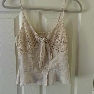 Cream lace casual blouse with flowy bottom and tie front.